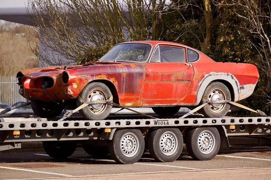 An unwanted car being towed away from a property