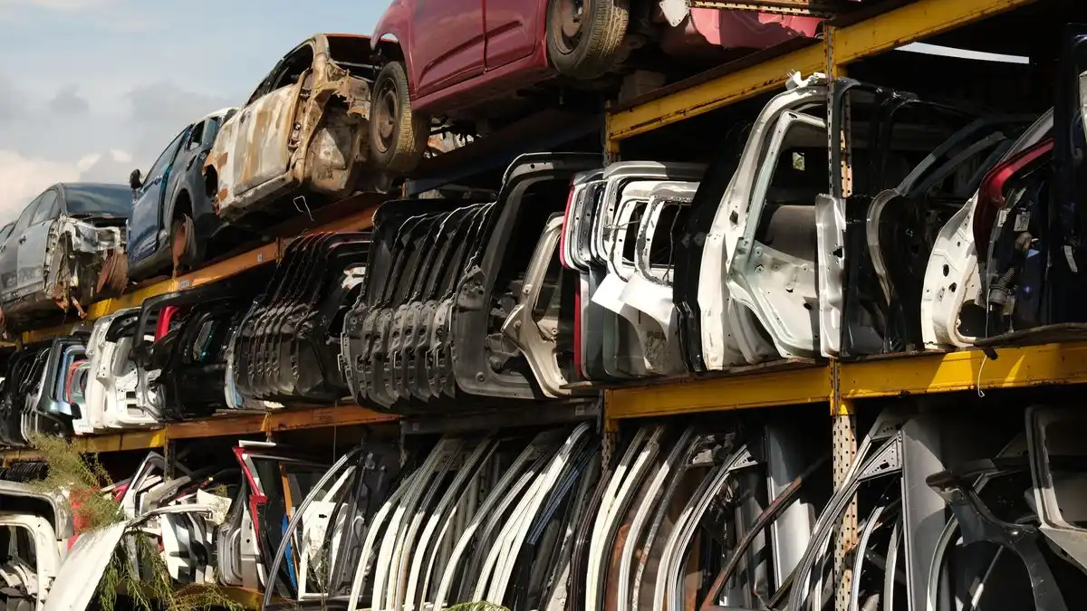 A wrecked car being stripped for parts and recycling